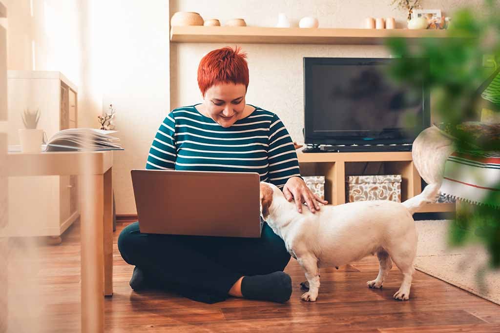 woman working from home with dog